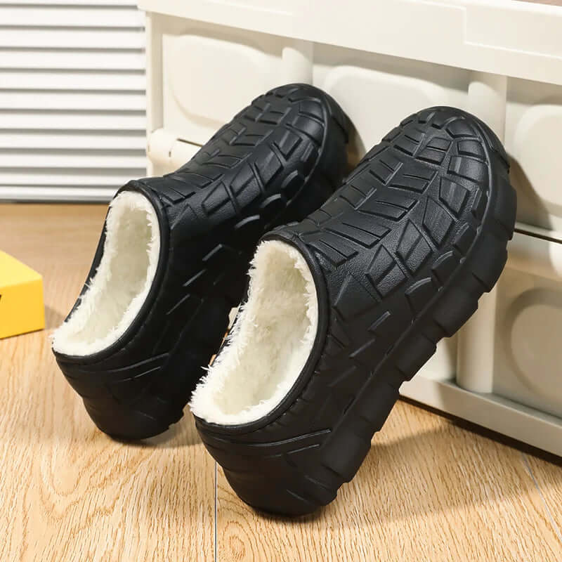 Fleece-lined waterproof shoes featuring a black exterior and soft inner lining, perfect for winter warmth and outdoor activities.
