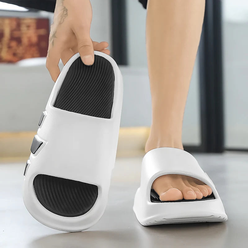 Black non-slip EVA summer slippers with deep grooved tread pattern