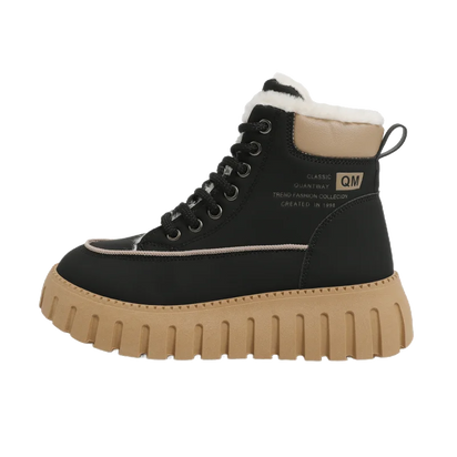 Black boot with tan sole on a white background