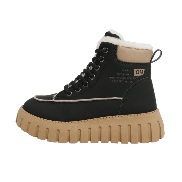 Black boot with tan sole on a white background