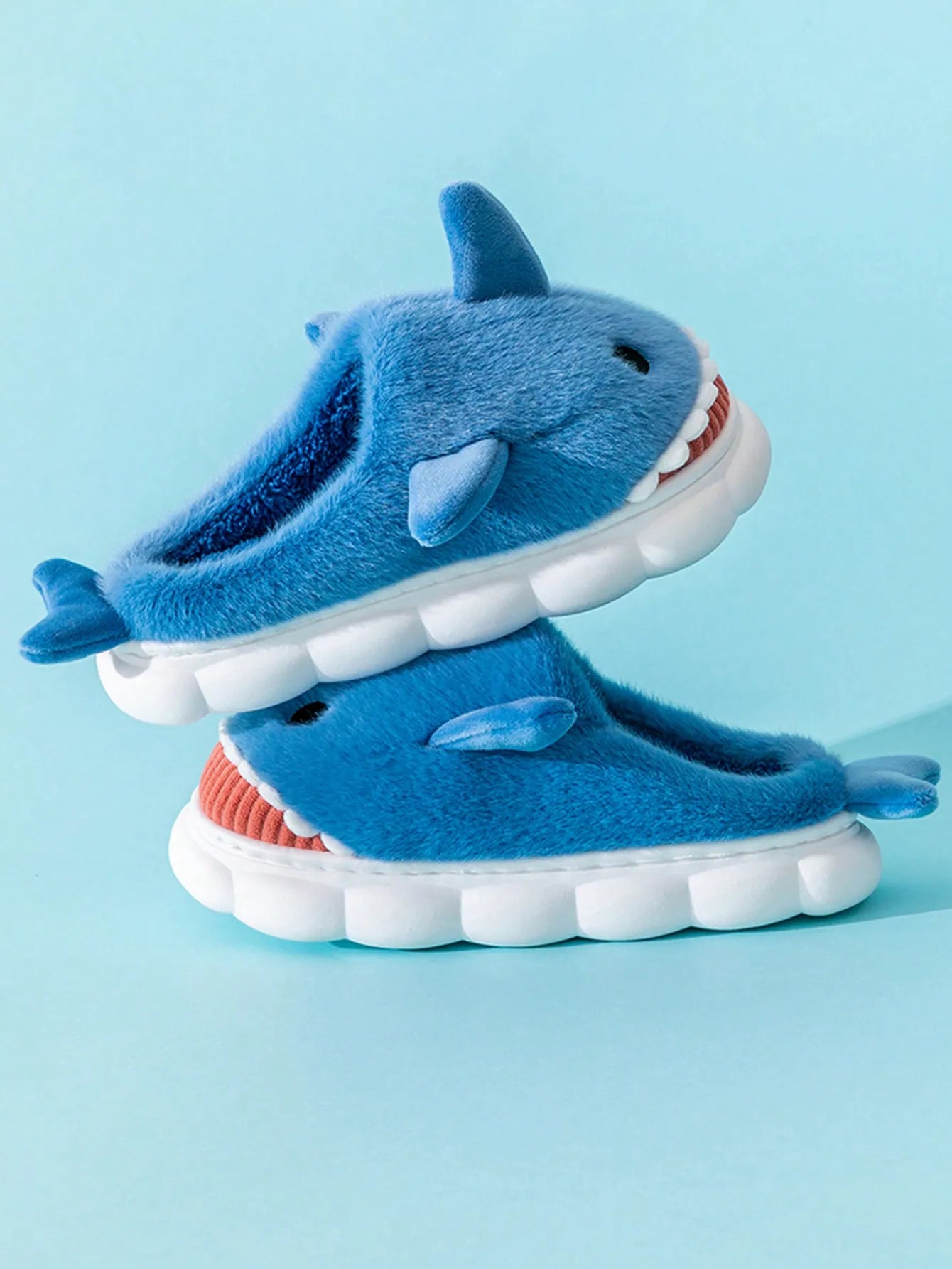 Man wearing cartoon shark slippers at home for comfortable indoor lounging