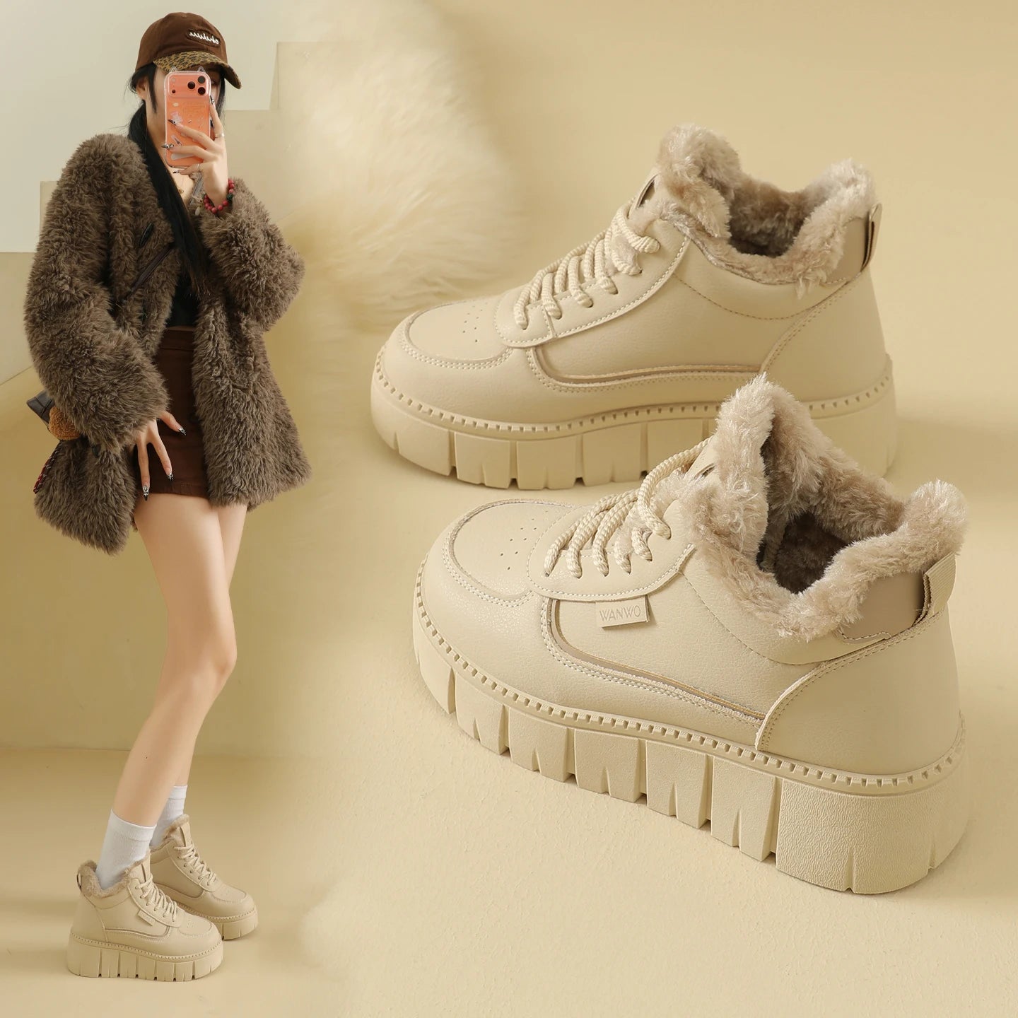 Beige winter boots with fur lining worn by a person on a beige background
