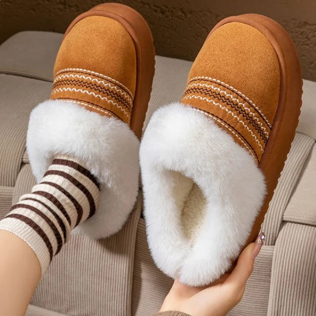 Women's plush slippers in pink showing soft fuzzy texture and non-slip sole