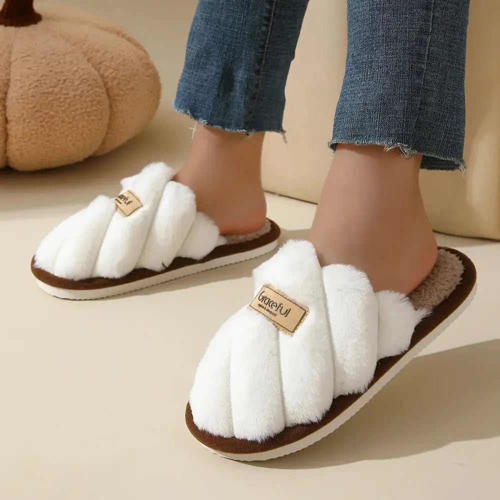 Pink fluffy slippers with white plush upper, brown sole, flat heel, lightweight cushioned sole